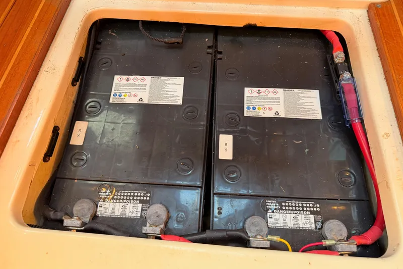 Slide: The Image of Battery compartment of a 1997 Hunter 430 sailboat, featuring dual batteries and wiring. - 91