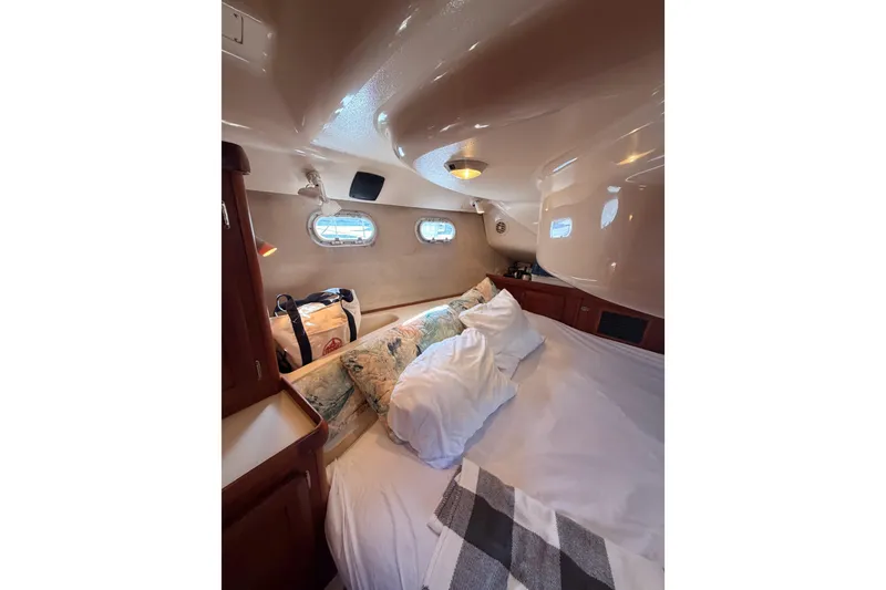 Slide: The Image of Cozy cabin interior of 1997 Hunter 430 sailboat with bed and portholes. - 79