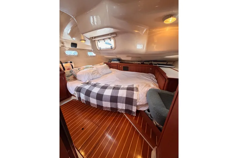 Slide: The Image of Cozy cabin interior of 1997 Hunter 430 sailboat with bed and wooden flooring. - 74