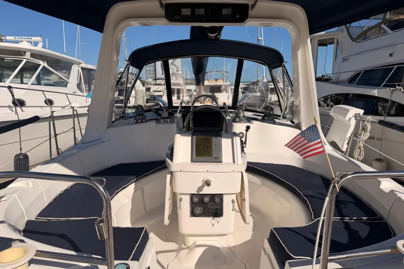 Slide: The Image of Cockpit of a 1997 Hunter 430 sailboat with navigation equipment and American flag. - 7