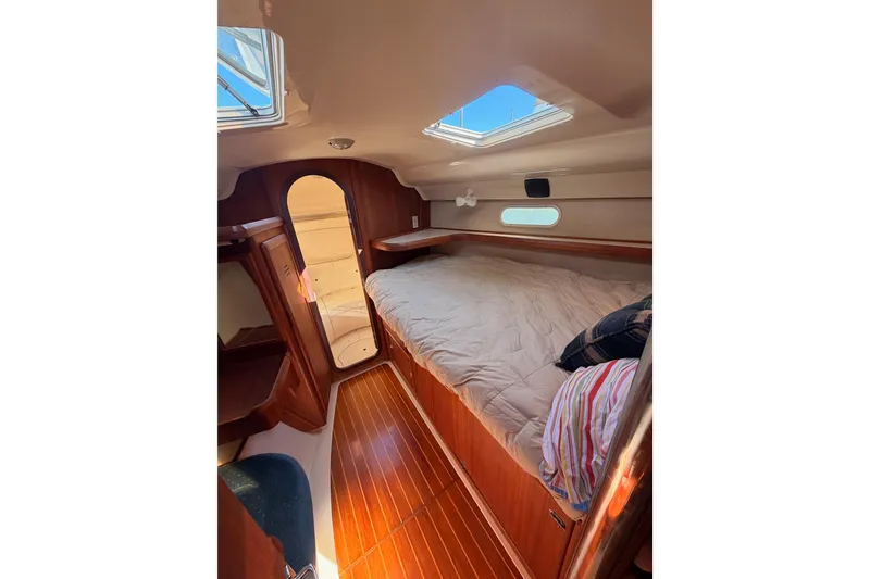 Slide: The Image of Cozy cabin interior of 1997 Hunter 430 sailboat with wooden flooring and skylight. - 51
