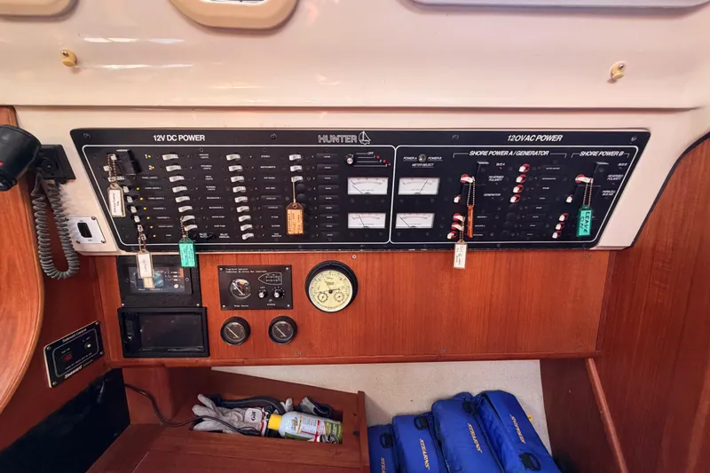 Slide: The Image of Electrical control panel on a 1997 Hunter 430 sailboat, featuring 12V DC and 120V AC systems. - 37