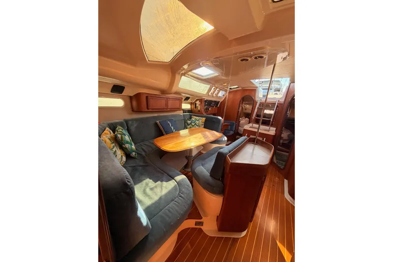 Slide: The Image of Interior of a 1997 Hunter 430 sailboat with cozy seating and wooden accents. - 66