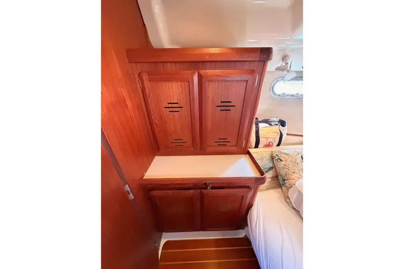 Slide: The Image of Wooden cabinetry in a 1997 Hunter 430 sailboat interior, featuring a cozy cabin space. - 78