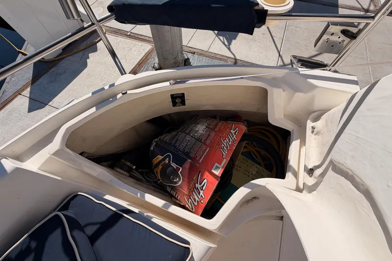 Slide: The Image of Storage compartment on a 1997 Hunter 430 sailboat, containing various boating supplies. - 95
