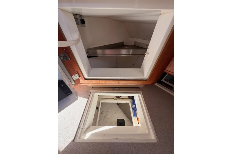 Slide: The Image of Interior storage compartments of a 1997 Hunter 430 sailboat, showcasing practical design. - 44