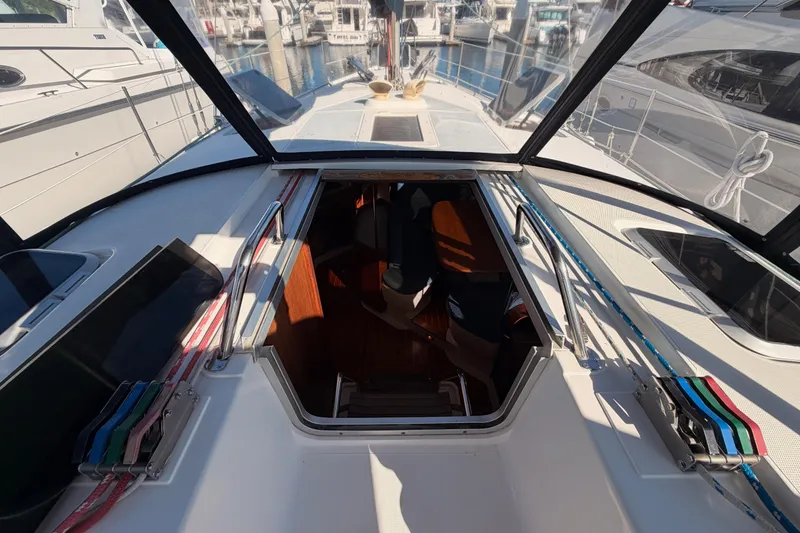Slide: The Image of Cockpit view of a 1997 Hunter 430 sailboat, showcasing the entrance to the cabin. - 32