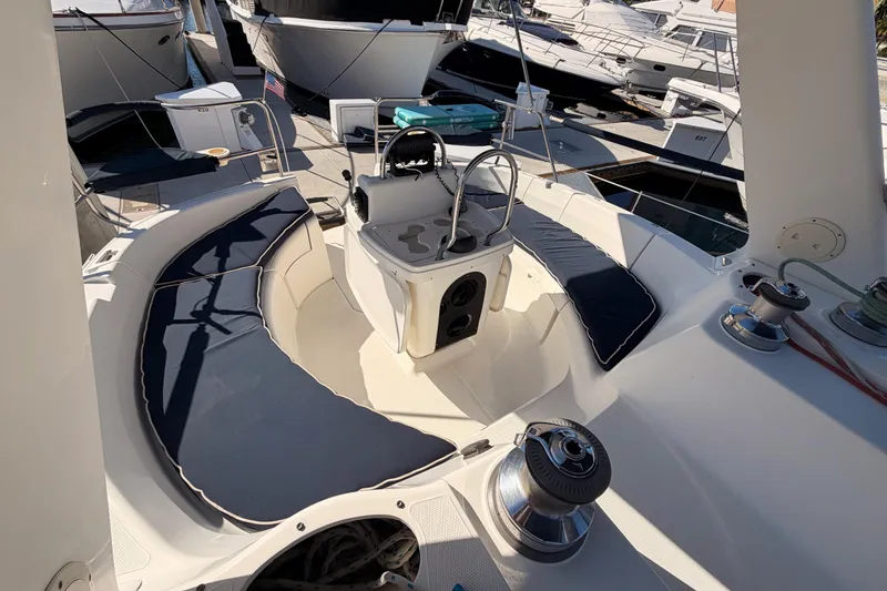 Slide: The Image of Cockpit of a 1997 Hunter 430 sailboat with cushioned seating and steering wheel. - 28