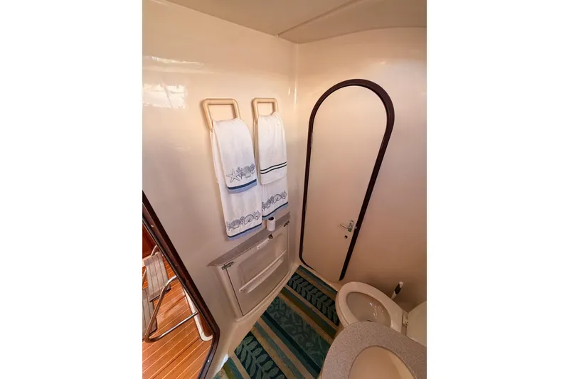 Slide: The Image of Bathroom interior of 1997 Hunter 430 yacht with towels and striped rug. - 73