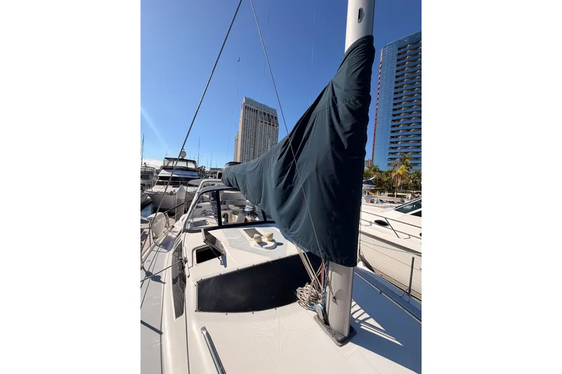 Slide: The Image of Sailboat Hunter 430, 1997 model, docked in marina with cityscape background. - 24