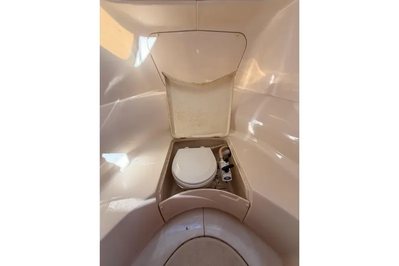 Slide: The Image of Compact marine toilet in a 1997 Hunter 430 sailboat bathroom. - 60