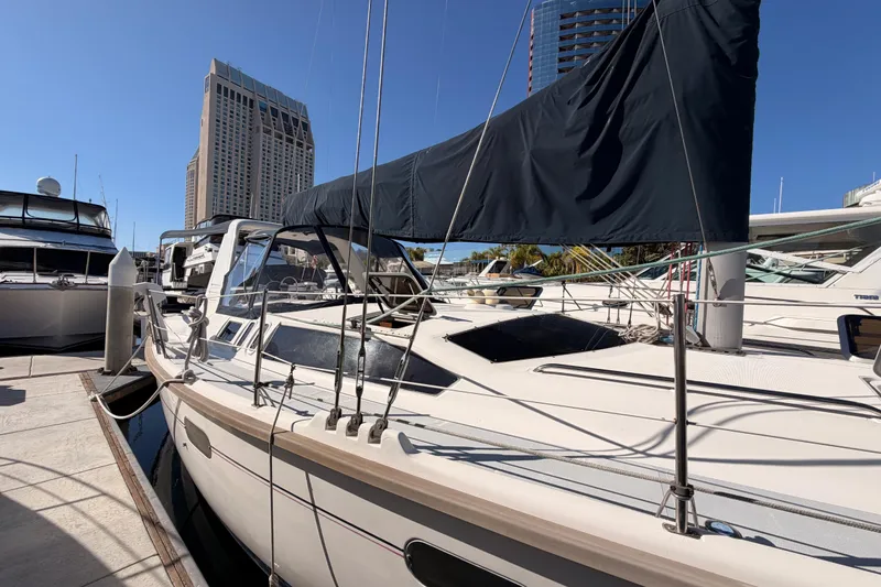Slide: The Image of Hunter 430 sailboat from 1997 docked at marina with cityscape background. - 3