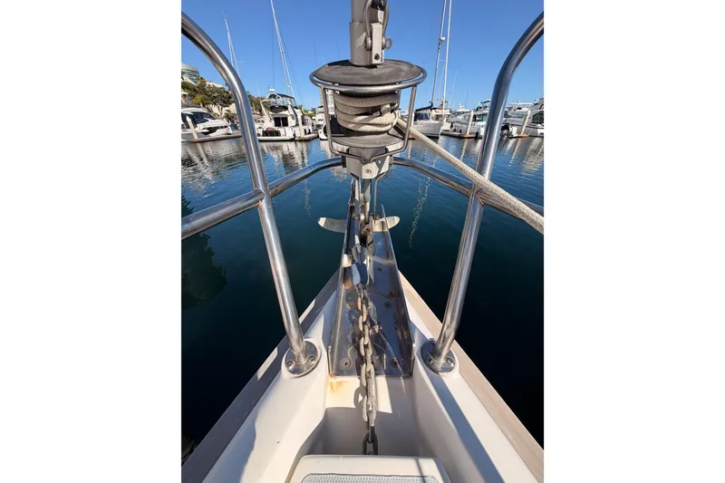 Slide: The Image of Bow view of a 1997 Hunter 430 sailboat at a marina, featuring anchor and railing. - 22
