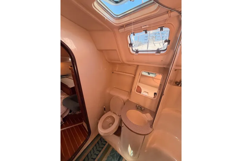 Slide: The Image of Interior of 1997 Hunter 430 yacht bathroom with skylight and compact design. - 72