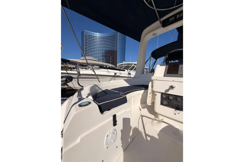 Slide: The Image of Sailboat cockpit view of 1997 Hunter 430 with modern marina backdrop. - 8