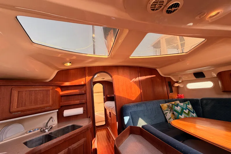 Slide: The Image of Interior of a 1997 Hunter 430 sailboat with wood finishes and skylights. - 49