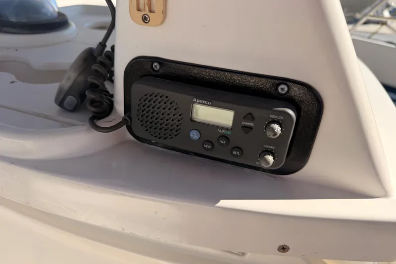 Slide: The Image of VHF radio on 1997 Hunter 430 sailboat, featuring Apelco VHF5160 model. - 13