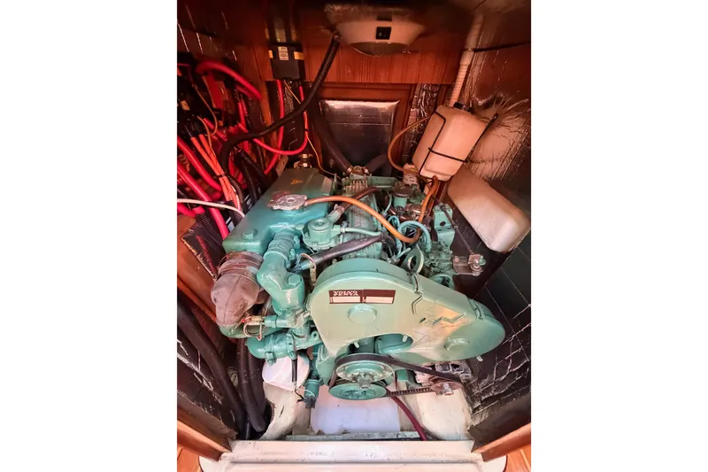 Slide: The Image of Engine compartment of a 1997 Hunter 430 sailboat, featuring a green marine engine. - 87