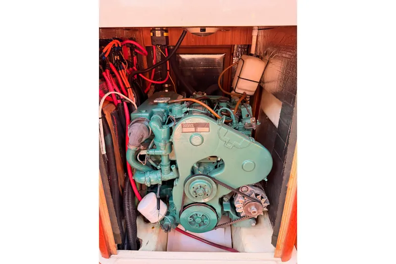 Slide: The Image of Engine compartment of a 1997 Hunter 430 sailboat, featuring a green marine engine. - 85