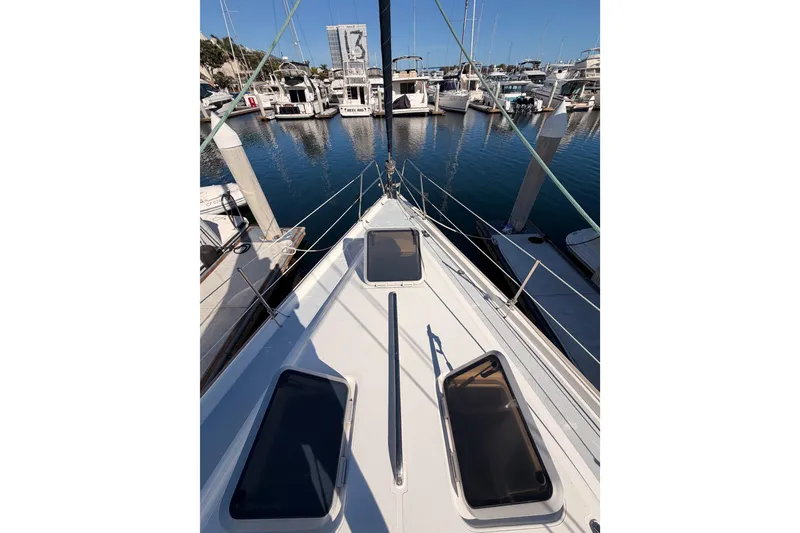 Slide: The Image of Sailboat Hunter 430, 1997 model, docked at marina with clear blue water. - 19