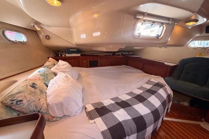 Slide: The Image of Cozy cabin interior of a 1997 Hunter 430 sailboat with bed and seating area. - 80