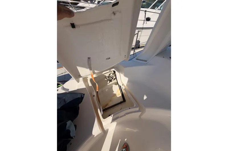 Slide: The Image of Open hatch on 1997 Hunter 430 sailboat deck, revealing storage compartment. - 97