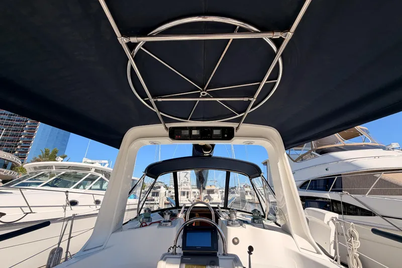Slide: The Image of Cockpit view of a 1997 Hunter 430 sailboat docked at a marina. - 11