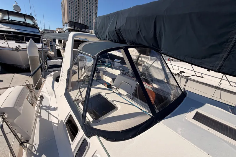 Slide: The Image of Sailboat Hunter 430, 1997 model, docked at marina with covered cockpit. - 26