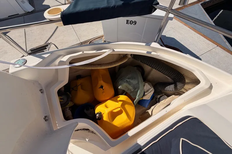 Slide: The Image of Storage compartment on a 1997 Hunter 430 sailboat with yellow fuel containers and equipment. - 96