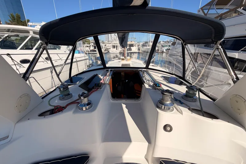 Slide: The Image of Cockpit view of a 1997 Hunter 430 sailboat docked at a marina. - 29