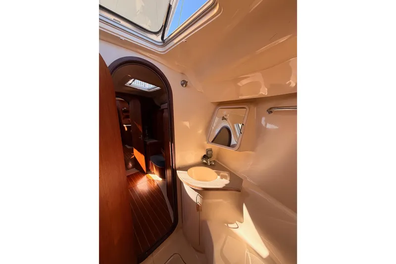 Slide: The Image of Interior of 1997 Hunter 430 yacht bathroom with sink and mirror. - 61