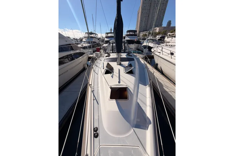 Slide: The Image of 1997 Hunter 430 sailboat docked in marina, surrounded by other boats. - 23