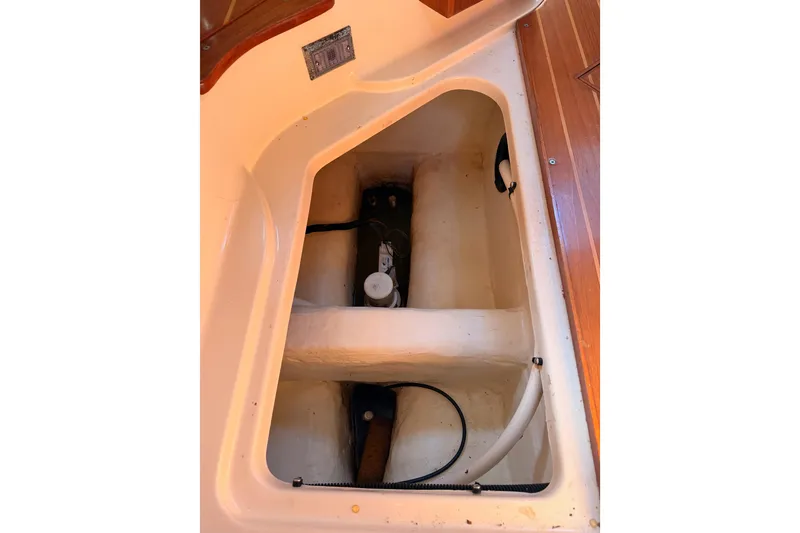 Slide: The Image of Interior compartment of a 1997 Hunter 430 sailboat, showcasing storage and mechanical components. - 93