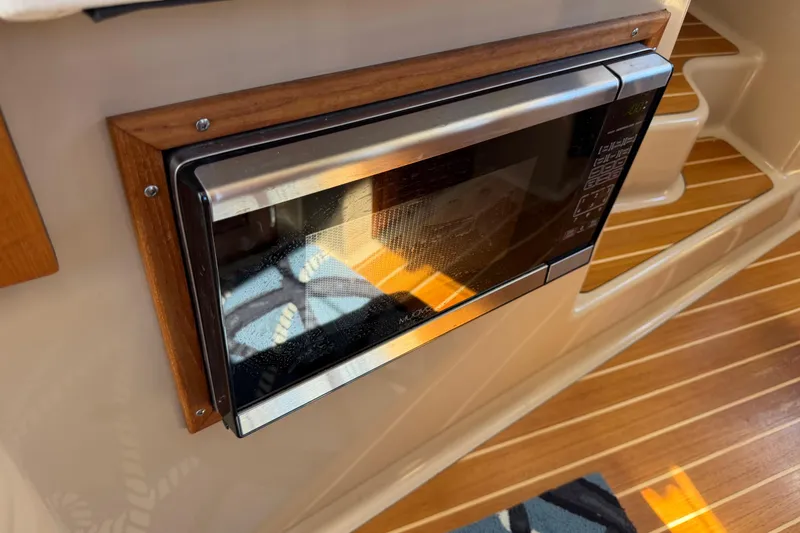 Slide: The Image of Built-in microwave on 2017 Ranger Tugs R-31 S boat with wooden interior accents. - 37