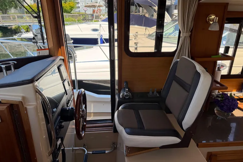 Slide: The Image of Interior of 2017 Ranger Tugs R-31 S boat with helm station and seating. - 27