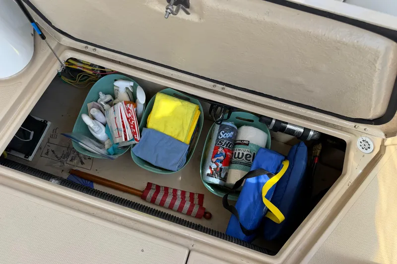 Slide: The Image of Storage compartment of 2017 Ranger Tugs R-31 S with cleaning supplies and tools. - 64