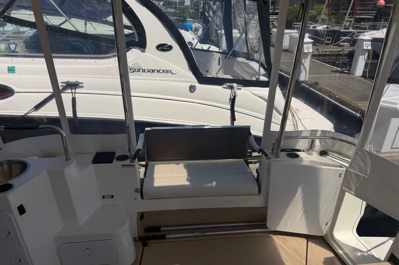 Slide: The Image of 2017 Ranger Tugs R-31 S boat interior with seating and docked Sundancer yacht. - 6