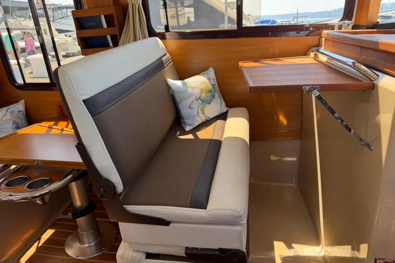 Slide: The Image of Interior of 2017 Ranger Tugs R-31 S with seating and foldable table. - 20