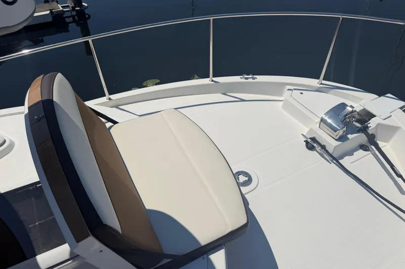 Slide: The Image of 2017 Ranger Tugs R-31 S boat deck with seating and railing, docked on calm water. - 68