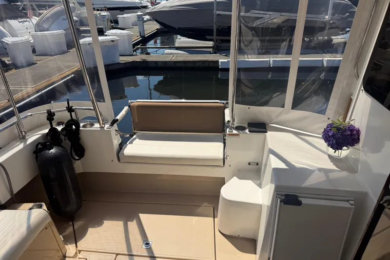 Slide: The Image of Interior view of 2017 Ranger Tugs R-31 S boat with seating and floral decor. - 4