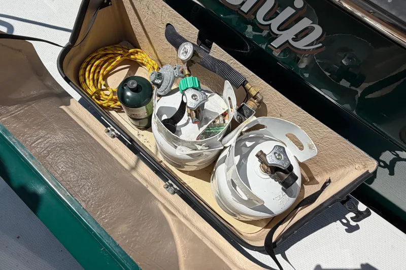 Slide: The Image of Storage compartment on 2017 Ranger Tugs R-31 S with propane tanks and rope. - 76