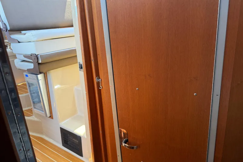 Slide: The Image of Interior view of 2017 Ranger Tugs R-31 S, featuring wooden door and compact seating area. - 44