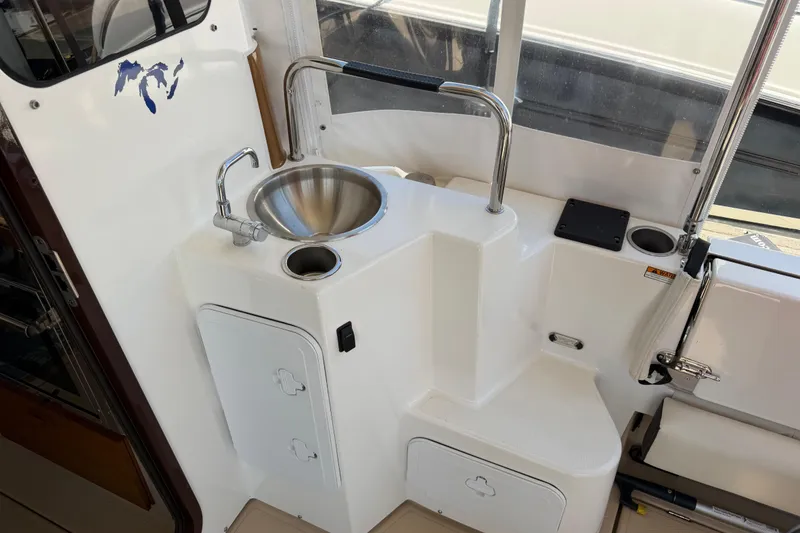 Slide: The Image of 2017 Ranger Tugs R-31 S boat interior with sink and storage compartments. - 10