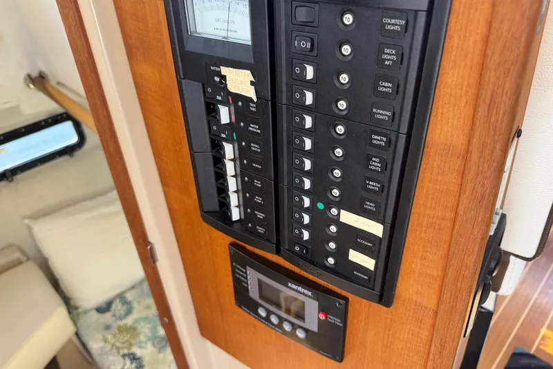 Slide: The Image of Electrical panel inside 2017 Ranger Tugs R-31 S boat, featuring various switches and controls. - 55