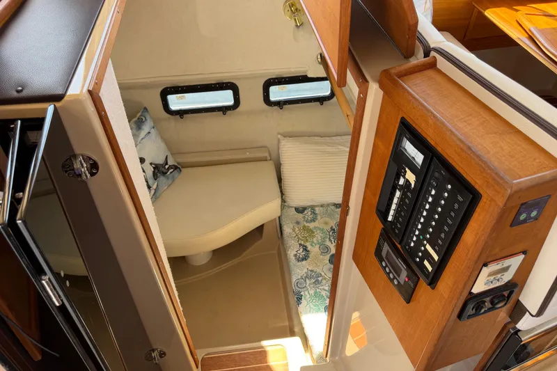 Slide: The Image of 2017 Ranger Tugs R-31 S cabin interior with control panel and cozy sleeping area. - 50