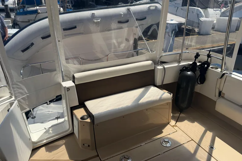 Slide: The Image of 2017 Ranger Tugs R-31 S boat interior with seating and docked view. - 7