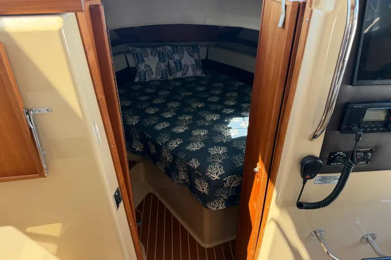 Slide: The Image of 2017 Ranger Tugs R-31 S cabin interior with bed and nautical decor. - 41