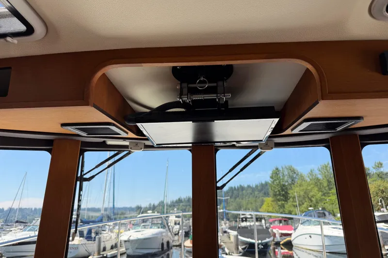 Slide: The Image of Interior view of 2017 Ranger Tugs R-31 S boat with marina background. - 38