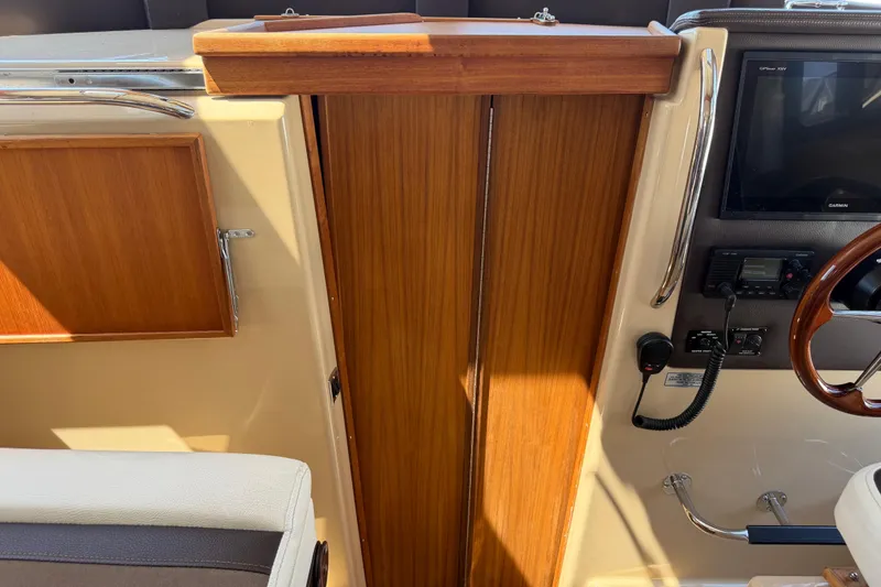 Slide: The Image of 2017 Ranger Tugs R-31 S interior helm with wood finish and navigation equipment. - 40