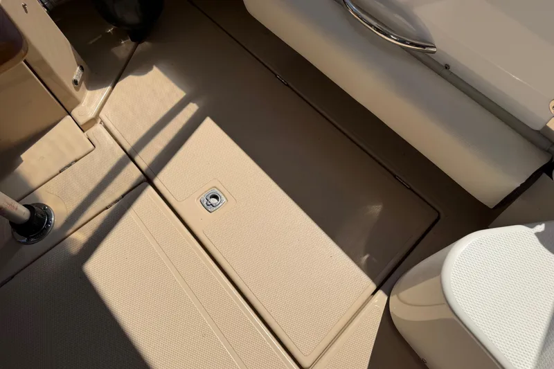 Slide: The Image of 2017 Ranger Tugs R-31 S boat interior with beige flooring and seating. - 63